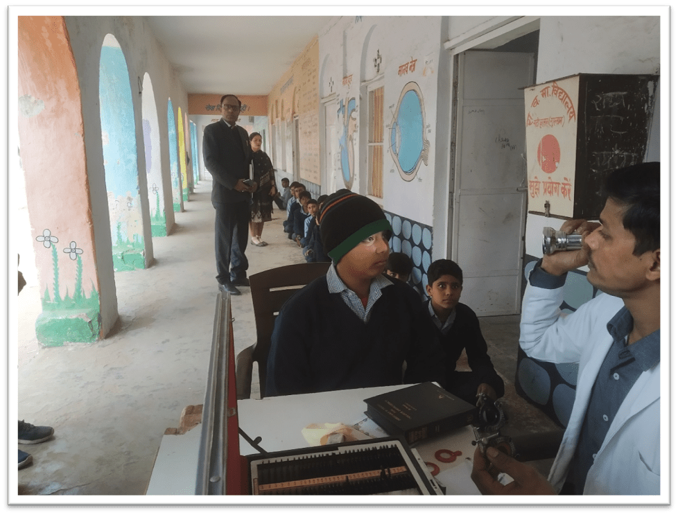 Optometrist is checking the eyes of Student beneficiaries at eye-treatment camp